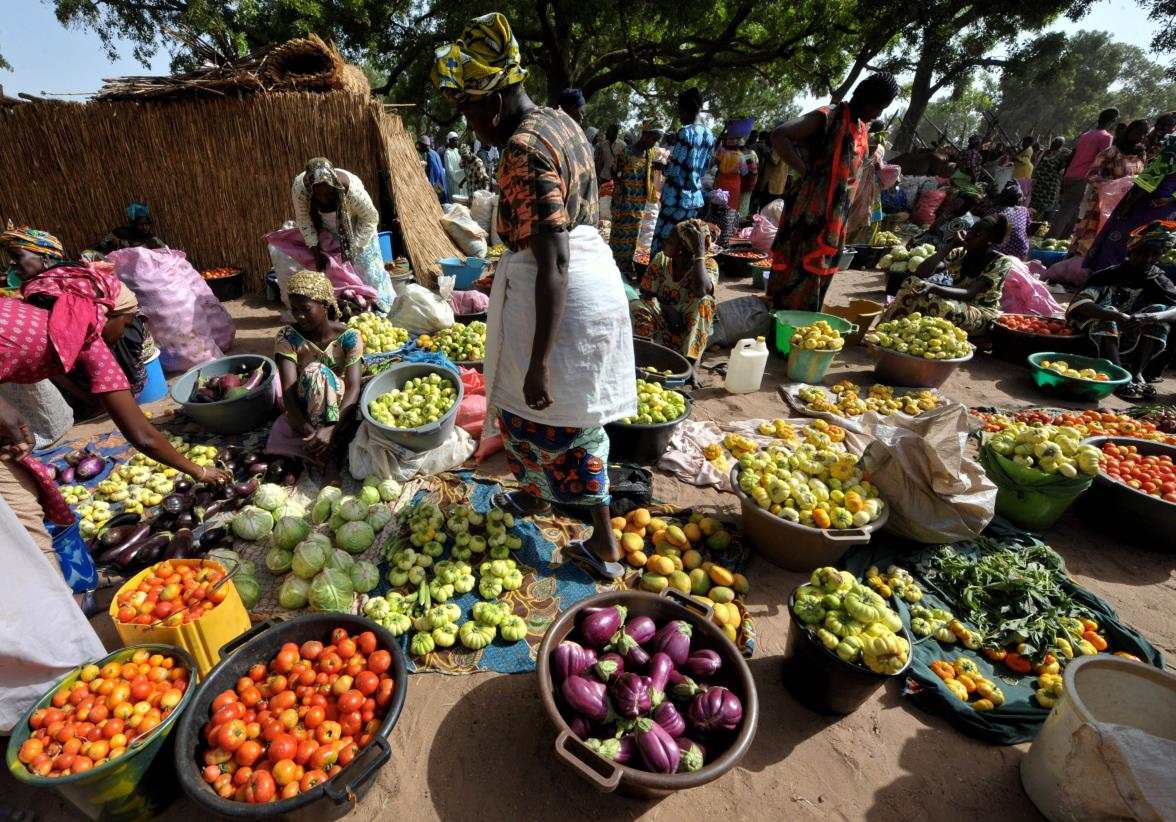 Vibrant African marketplace with farmers selling colorful fresh produce